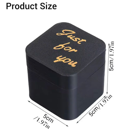 Black middle finger pop-up prank gift box with gold-coloured surprise