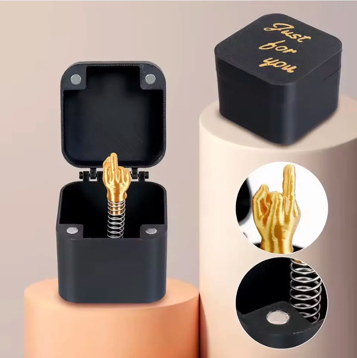 Black middle finger pop-up prank gift box with gold-coloured surprise
