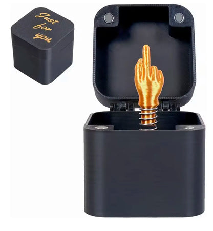 Black middle finger pop-up prank gift box with gold-coloured surprise